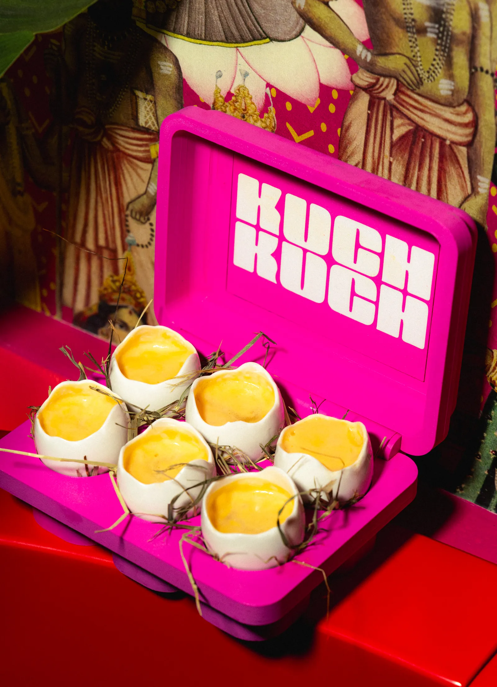 Pink branded box holding six small egg dishes