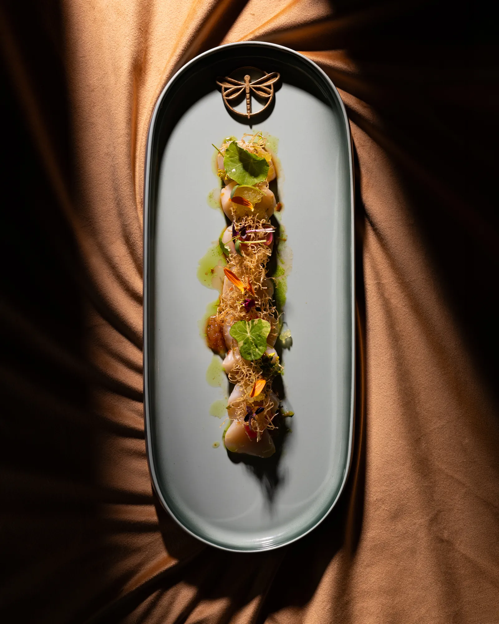 Starter plated on a long white dish, seen from above