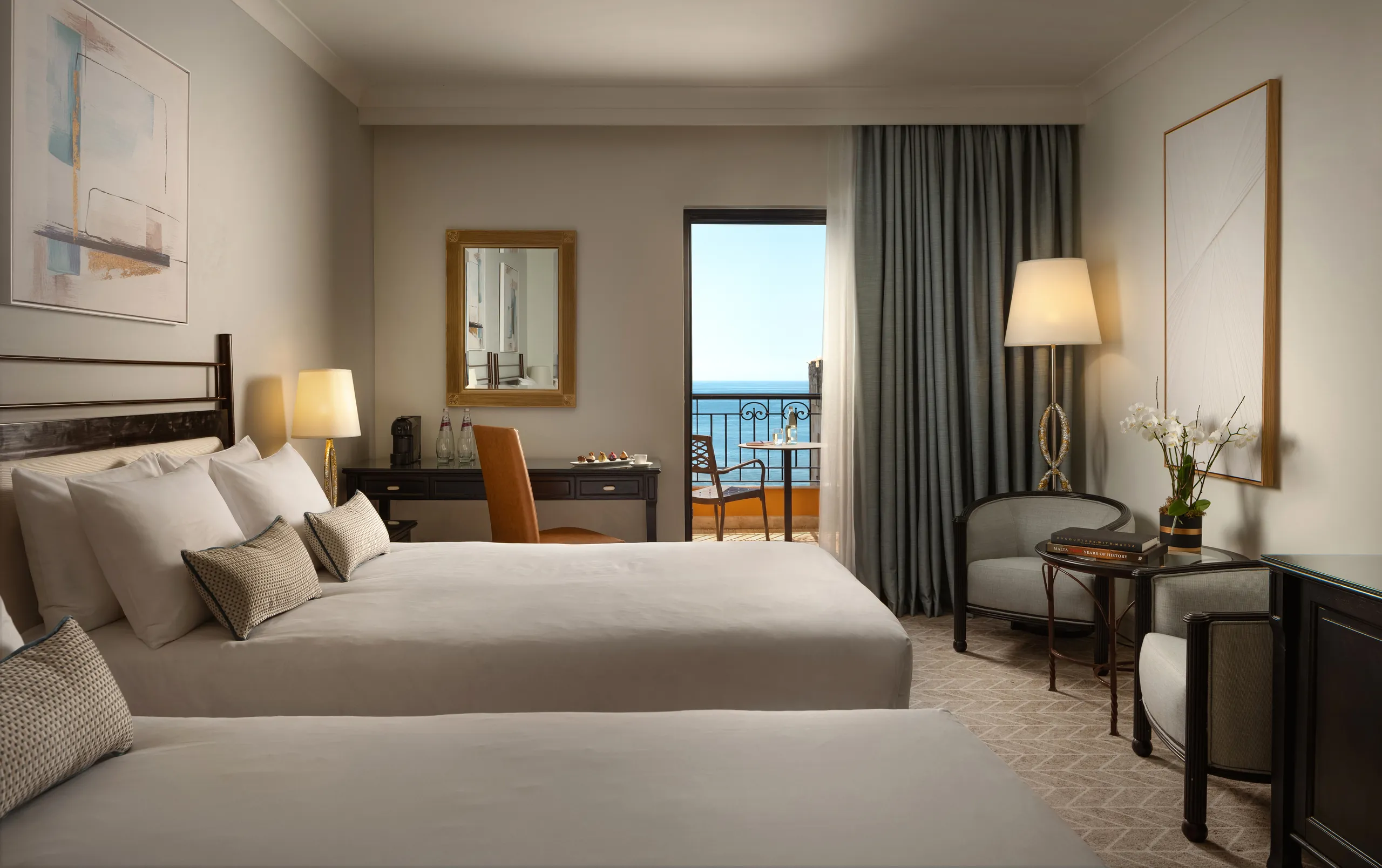 Twin guest room with a sea-view balcony at Corinthia St George's Bay