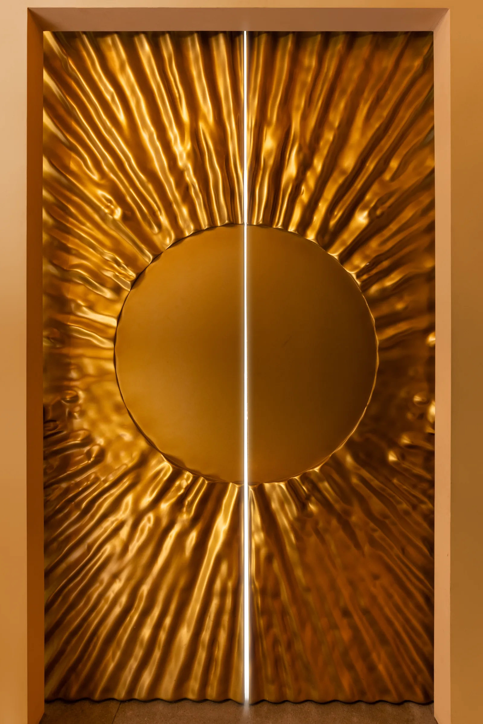 Golden sunburst relief on a pair of doors