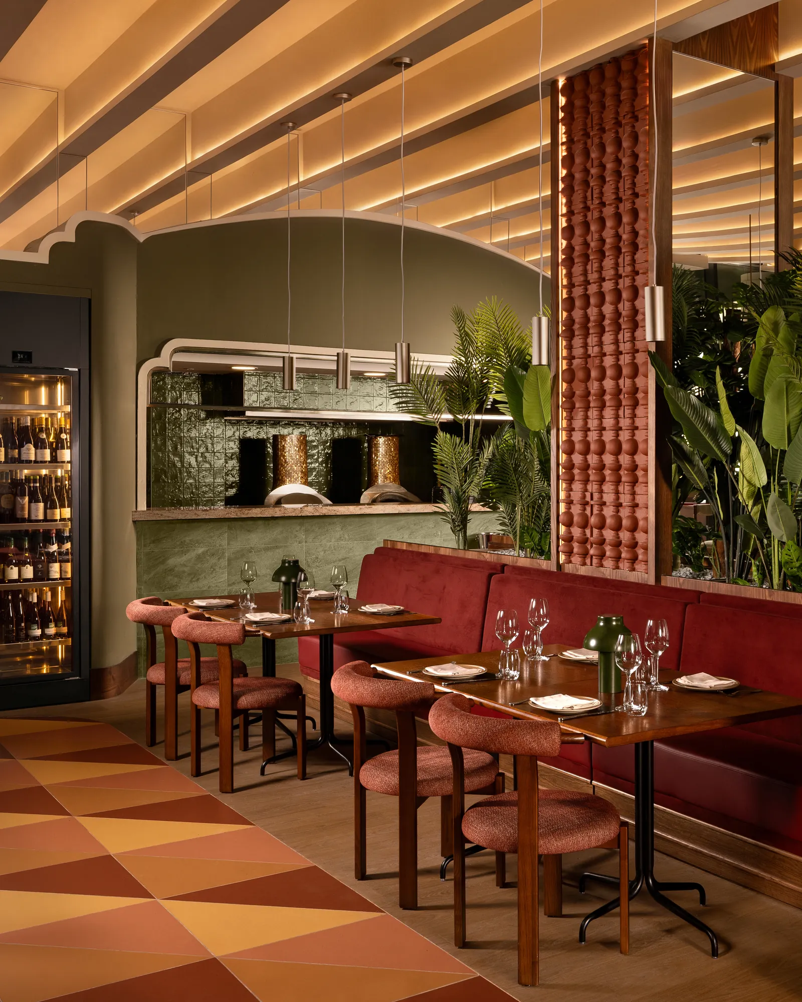 Tanvi dining room under a slatted timber ceiling, with banquette seating and a patterned floor