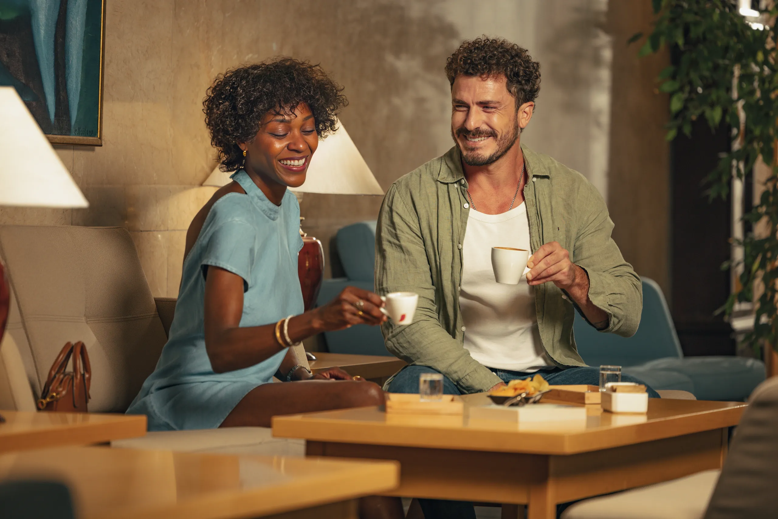 Couple having coffee together in a hotel lounge in Prague