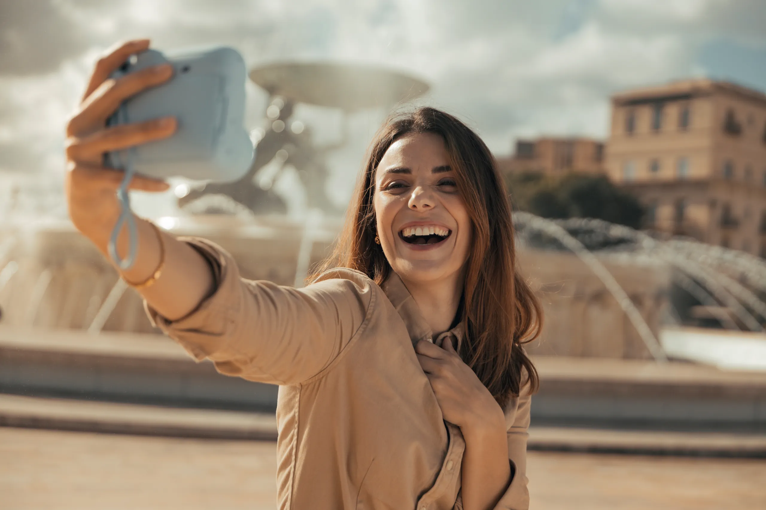 Woman taking a selfie in front of a fountain in Malta