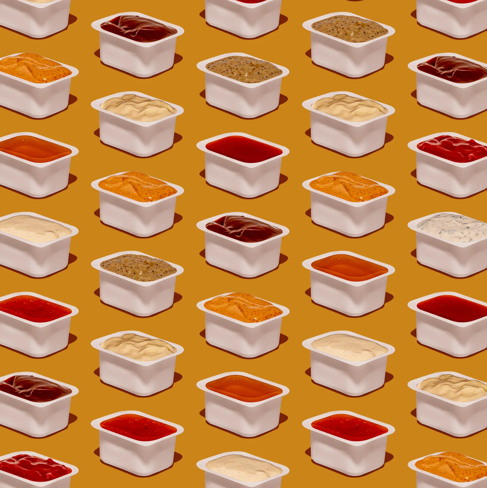 Rows of sauce pots in a repeating pattern on a mustard background, Chickoo