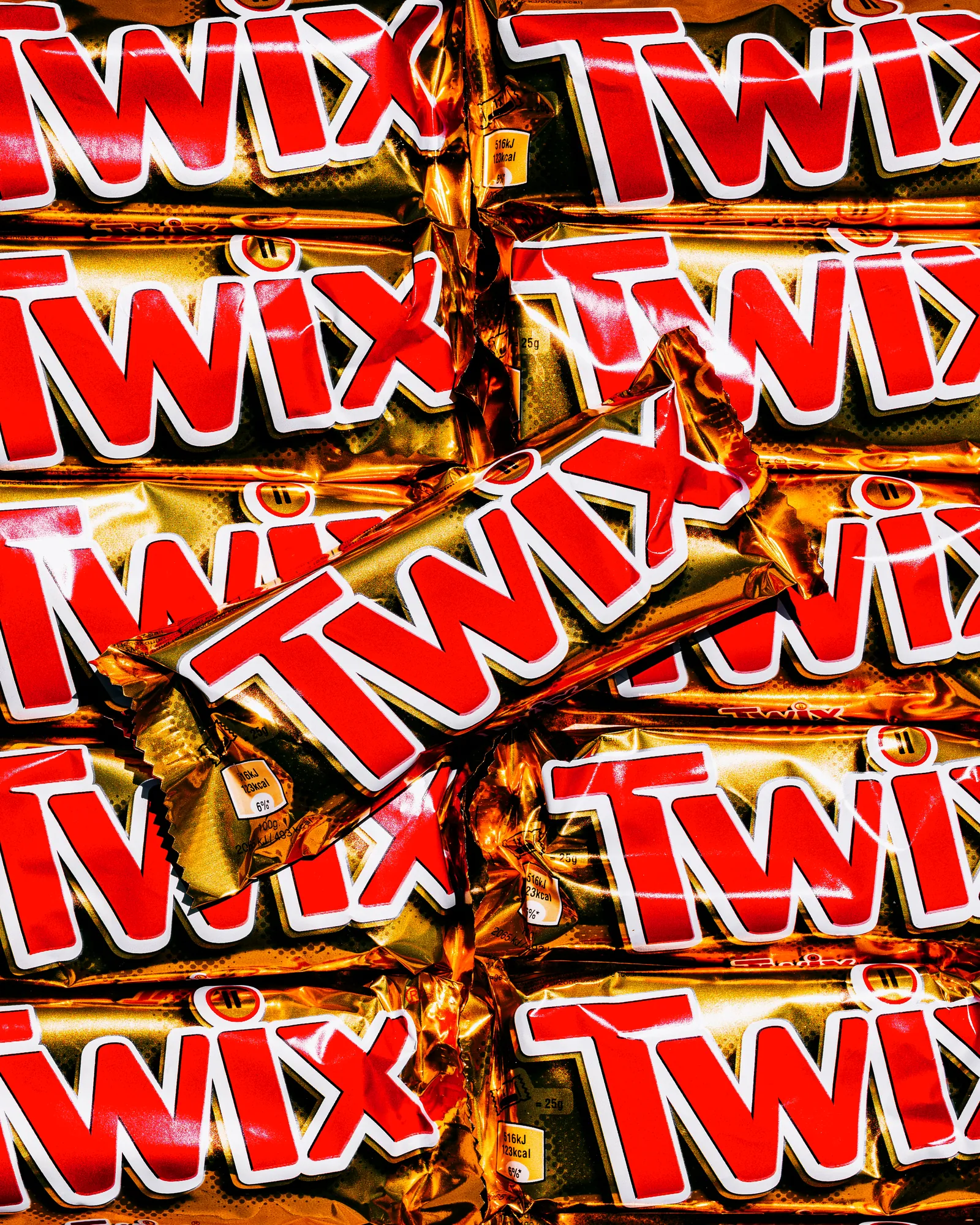 Twix chocolate bars piled in a dense pattern