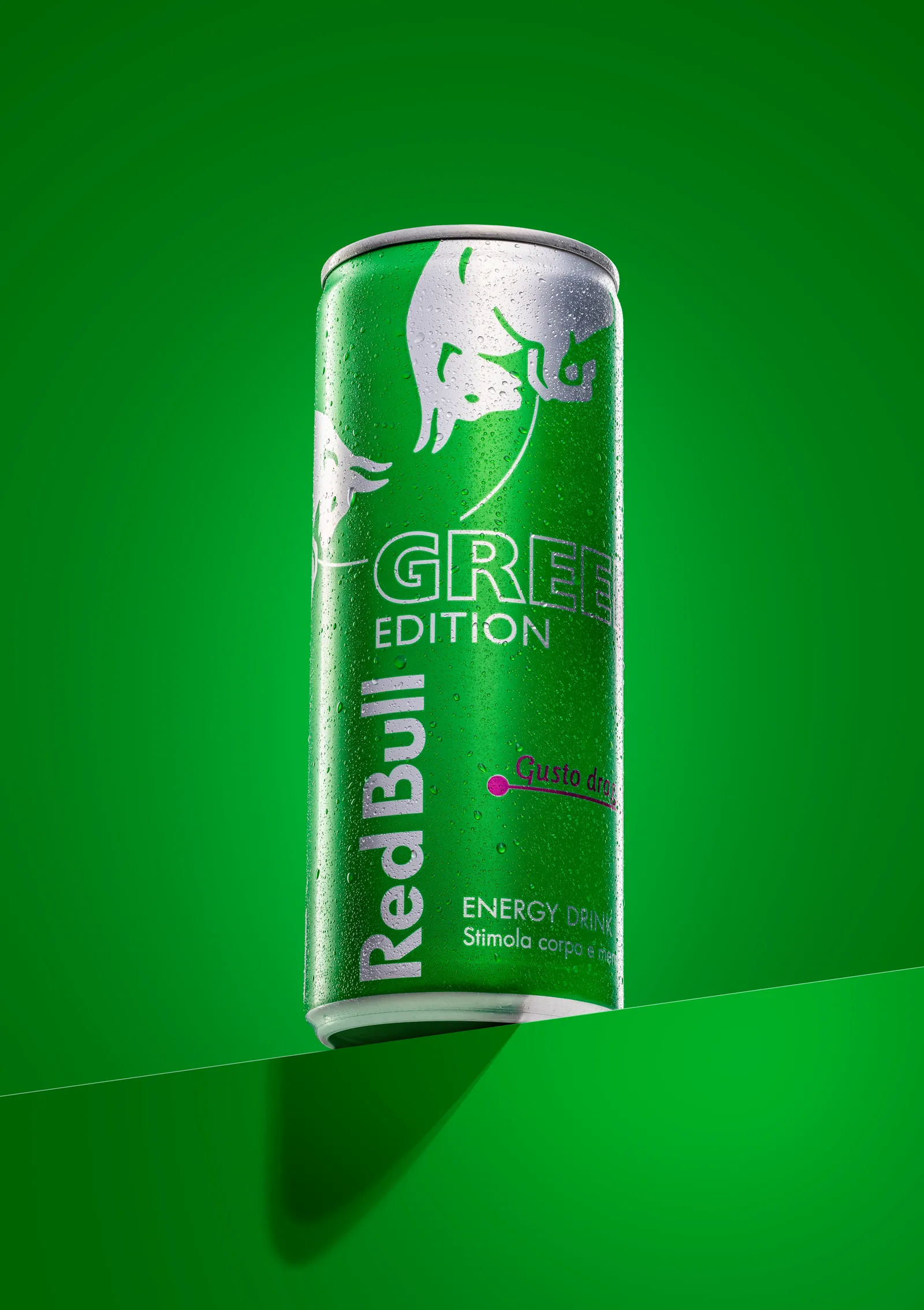 Green Red Bull can against a green background