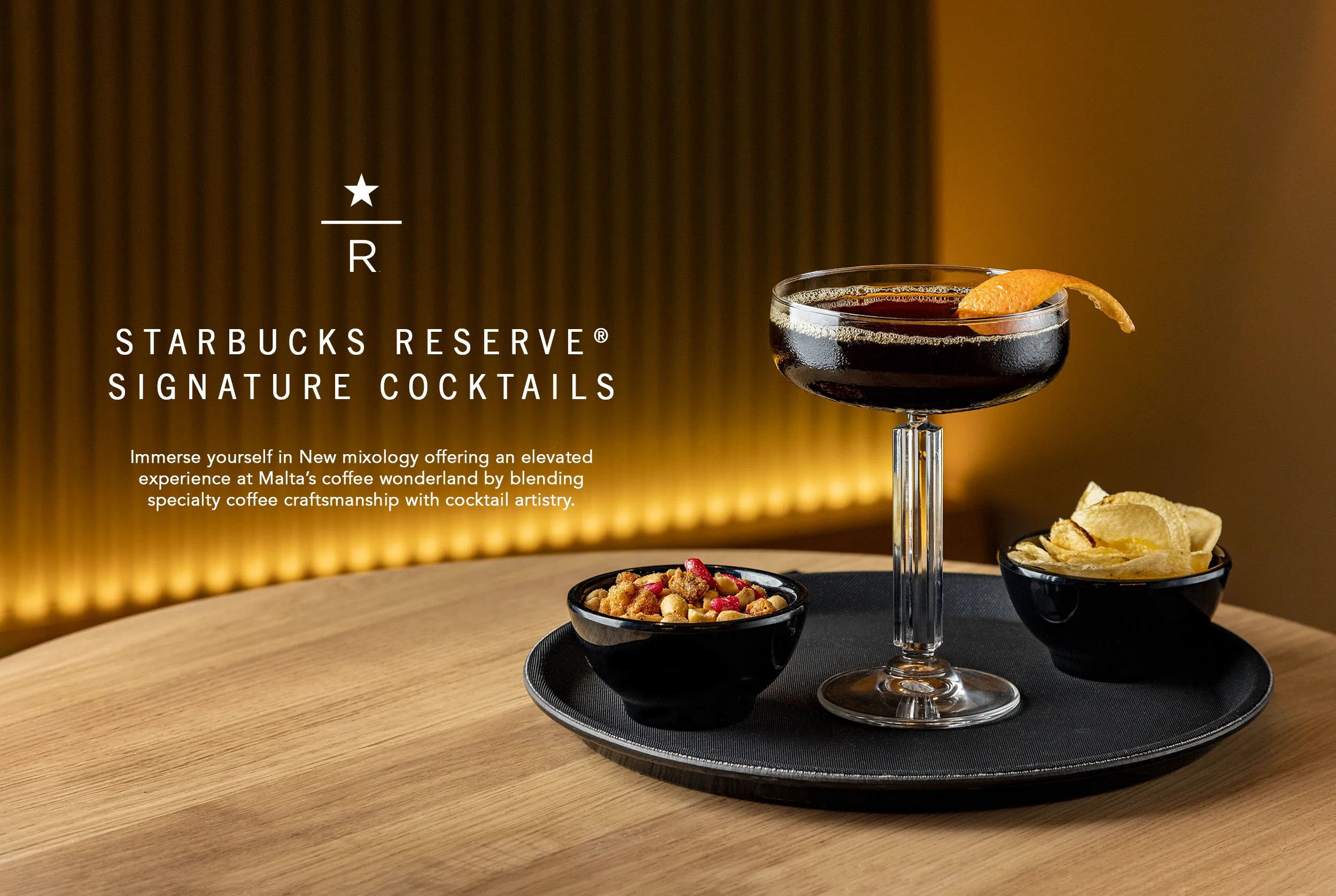 Coffee cocktail with an orange twist and bar snacks on a tray, Starbucks Reserve signature cocktails