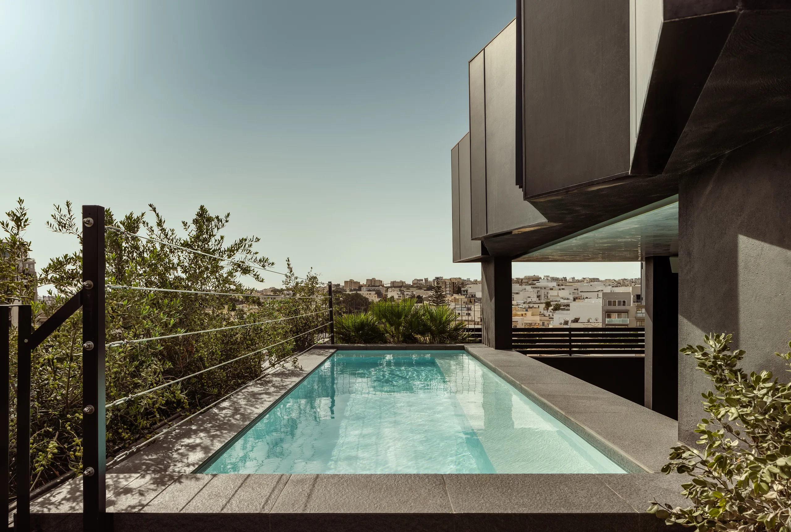 Small rooftop pool with a terrace and city views